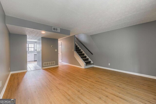 2498 Hidden Cove Ct Unit D, Gainesville, GA 30501 - kitchen with stainless steel appliances, light countertops, white cabinets, and light tile patterned floors