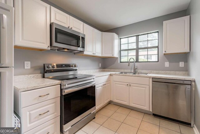 2498 Hidden Cove Ct Unit D, Gainesville, GA 30501 - kitchen featuring stainless steel appliances, white cabinetry, light tile patterned flooring, and light stone countertops