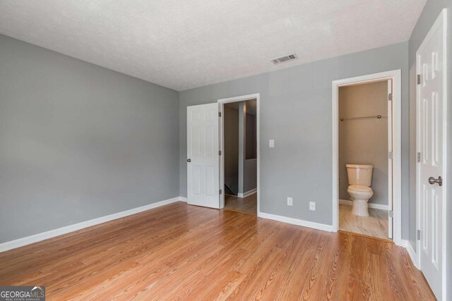 2498 Hidden Cove Ct Unit D, Gainesville, GA 30501 - empty room with light wood-type flooring, ceiling fan, and a textured ceiling