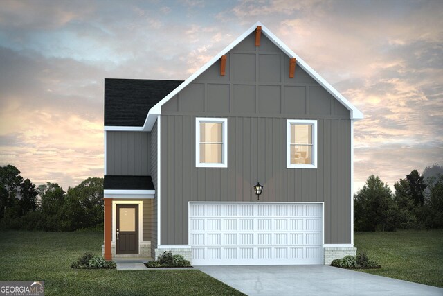 view of front of property featuring a garage and a lawn