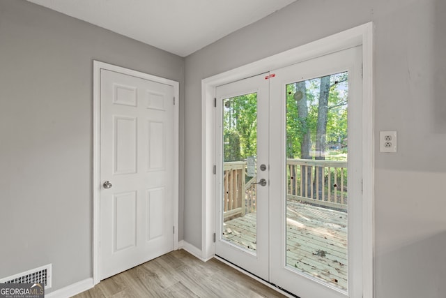 doorway featuring light hardwood / wood-style flooring and french doors