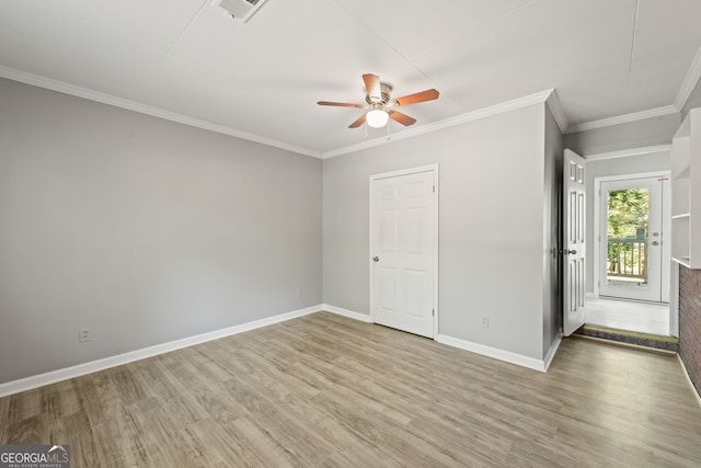 empty room featuring ornamental molding, hardwood / wood-style flooring, and ceiling fan