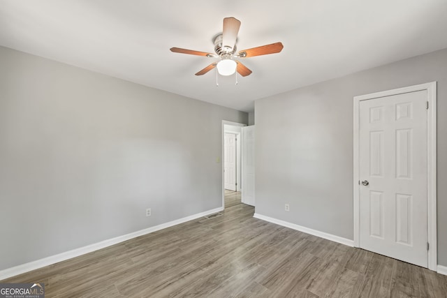 unfurnished bedroom featuring ceiling fan and light hardwood / wood-style floors