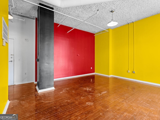 empty room with wood-type flooring