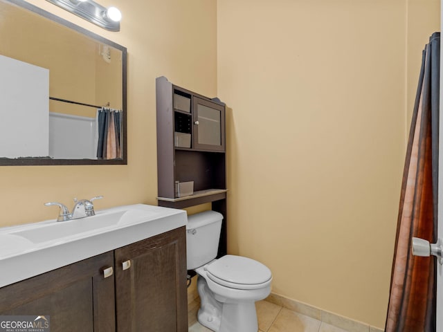 bathroom with vanity, tile patterned flooring, and toilet