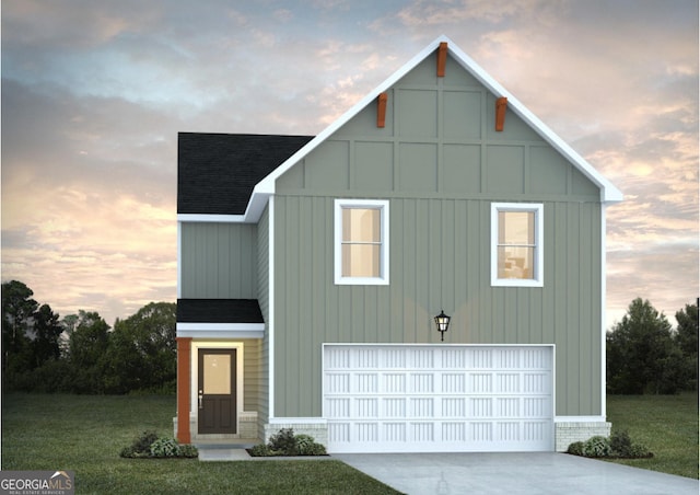 view of front of home with a yard and a garage