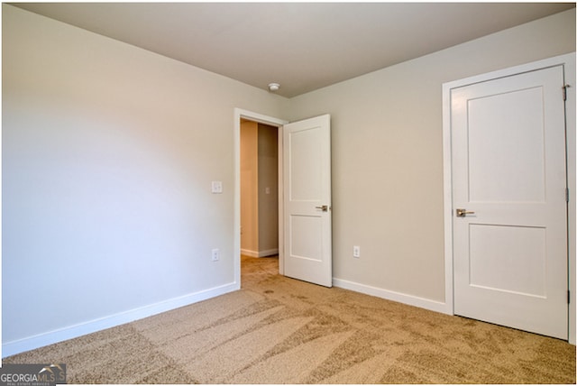 unfurnished bedroom with light carpet