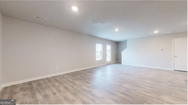 empty room with light hardwood / wood-style flooring