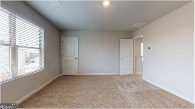 empty room with light colored carpet