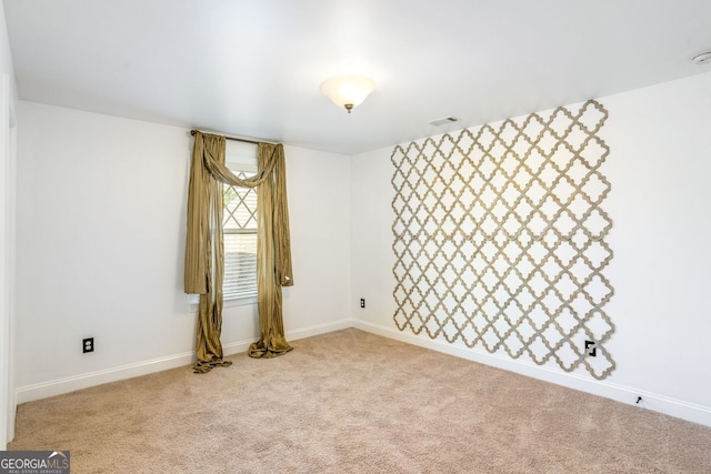 spare room with light carpet