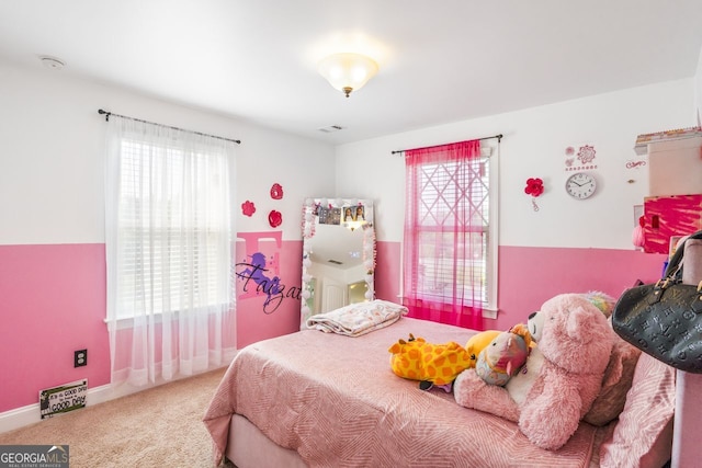 bedroom with multiple windows and carpet flooring