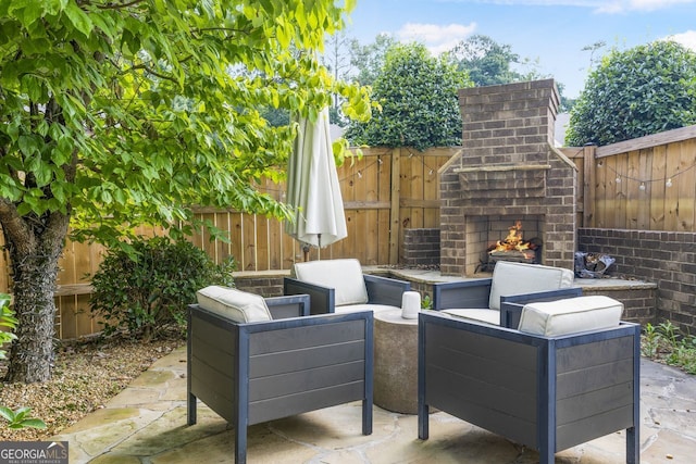 view of patio / terrace with an outdoor living space with a fireplace