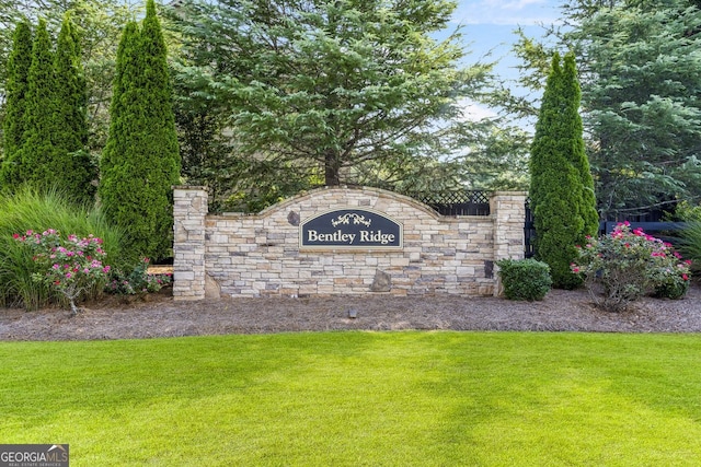 community / neighborhood sign with a lawn