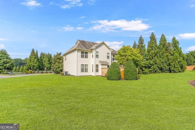 view of property exterior with a yard and central AC unit