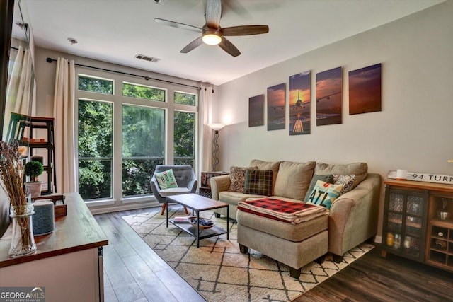 living room featuring hardwood / wood-style floors and ceiling fan