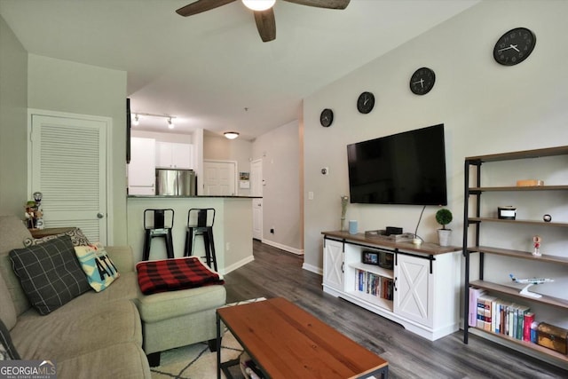 living room with ceiling fan, dark hardwood / wood-style flooring, and track lighting