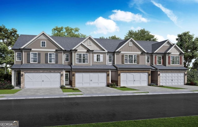 view of property featuring driveway, board and batten siding, and an attached garage