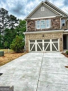 exterior space with concrete driveway and an attached garage