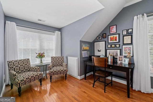 living room featuring hardwood / wood-style flooring, ceiling fan, and crown molding