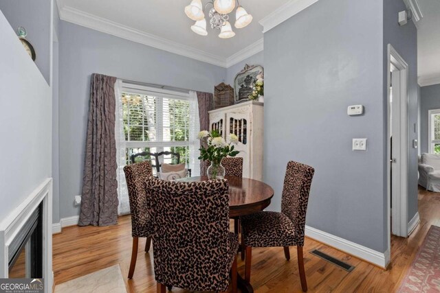 living room with french doors, hardwood / wood-style flooring, and crown molding