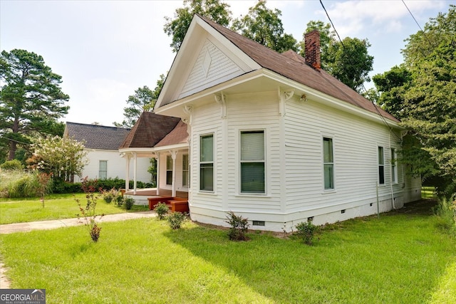 view of side of home with a lawn