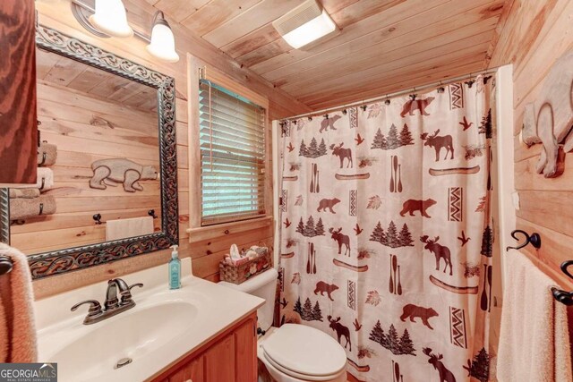 bathroom with wooden ceiling, vanity, wood walls, and toilet