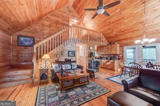 living room with wood walls, high vaulted ceiling, wood ceiling, and light hardwood / wood-style floors