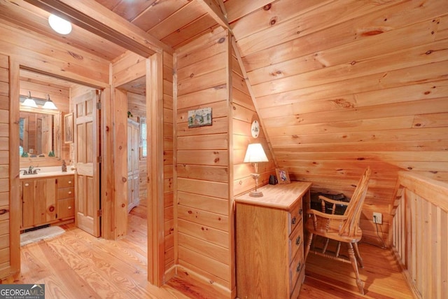 bathroom featuring hardwood / wood-style flooring, vanity, wooden walls, and wooden ceiling