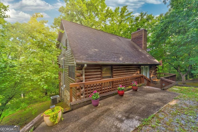 log home featuring central AC unit