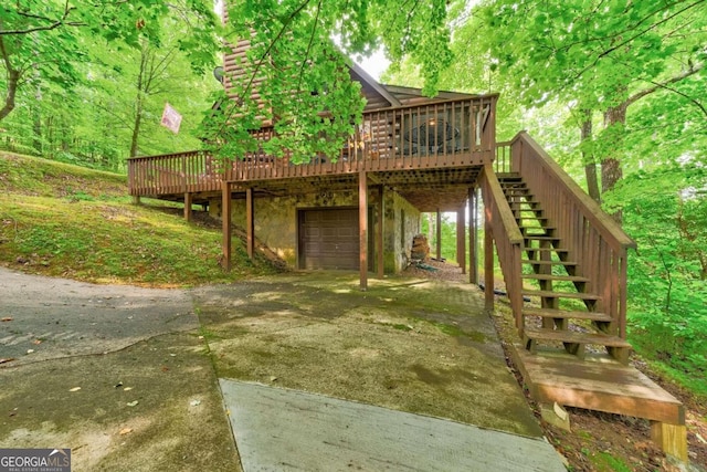 back of house with a deck and a garage