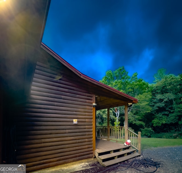 property exterior at twilight featuring a deck