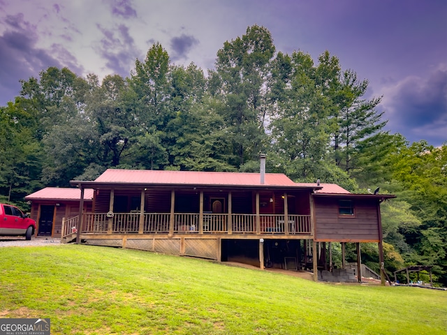 rear view of property with a lawn