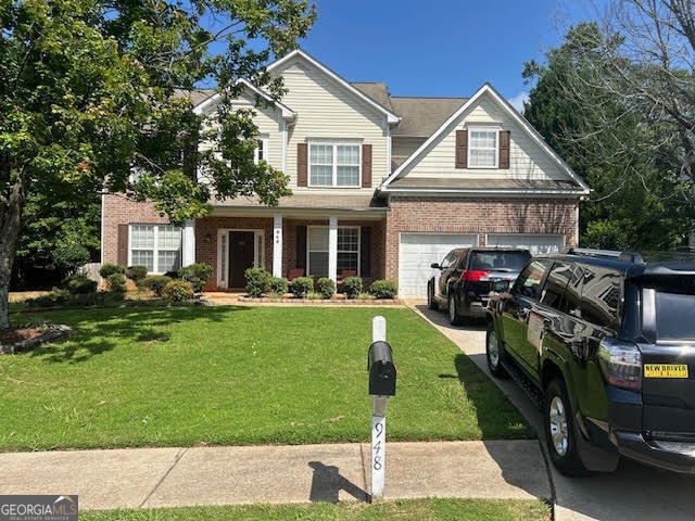 view of front of home with a front lawn and a garage