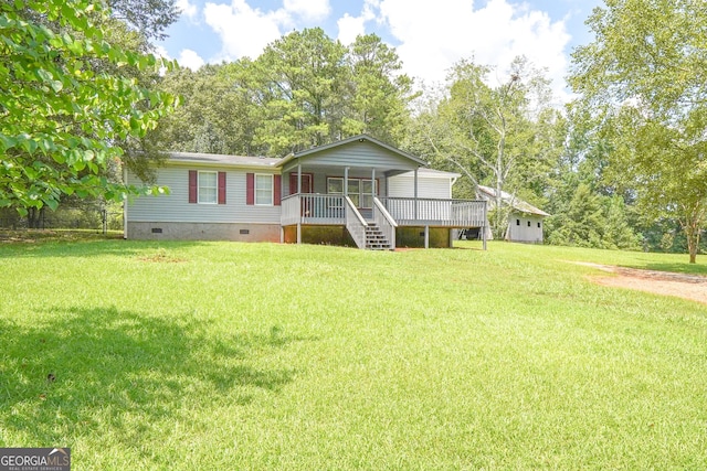 back of property with a wooden deck and a lawn