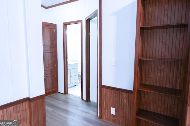 hall featuring hardwood / wood-style flooring and crown molding