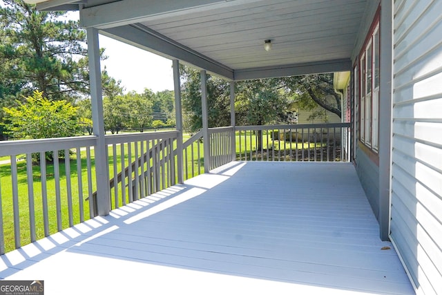 wooden terrace with a yard