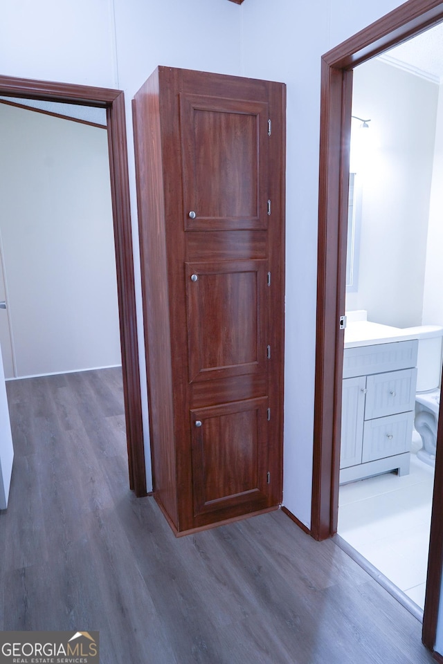 hallway with hardwood / wood-style floors