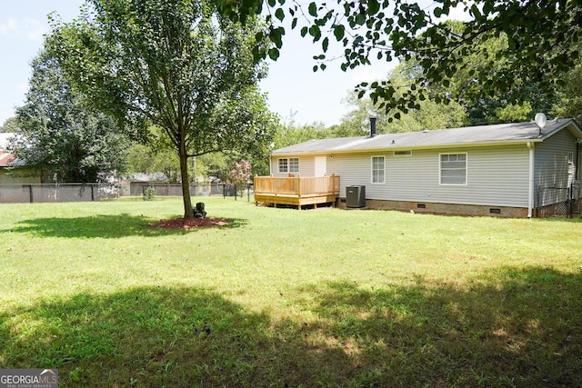 view of yard featuring central air condition unit and a wooden deck