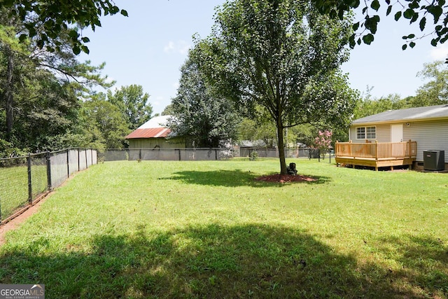 view of yard featuring cooling unit and a deck