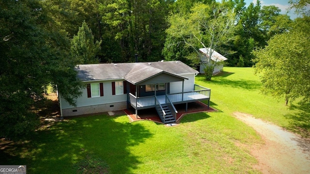 back of property with a yard and a wooden deck