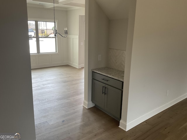 interior space with wood finished floors and baseboards