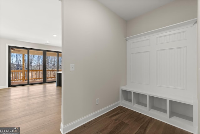 mudroom featuring wood finished floors and baseboards