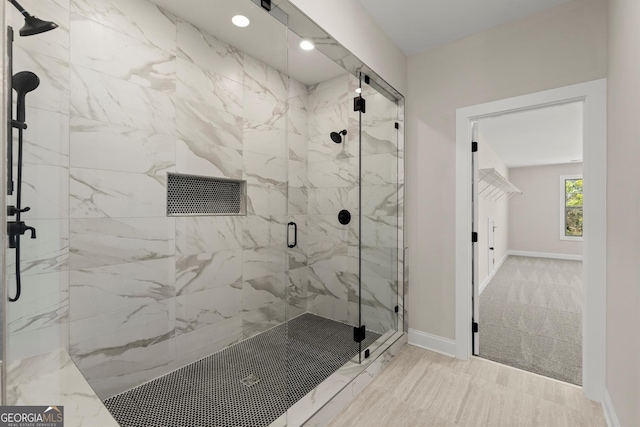 full bath featuring a marble finish shower, baseboards, and recessed lighting