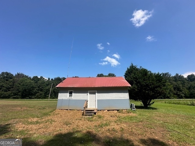 view of side of property with a lawn