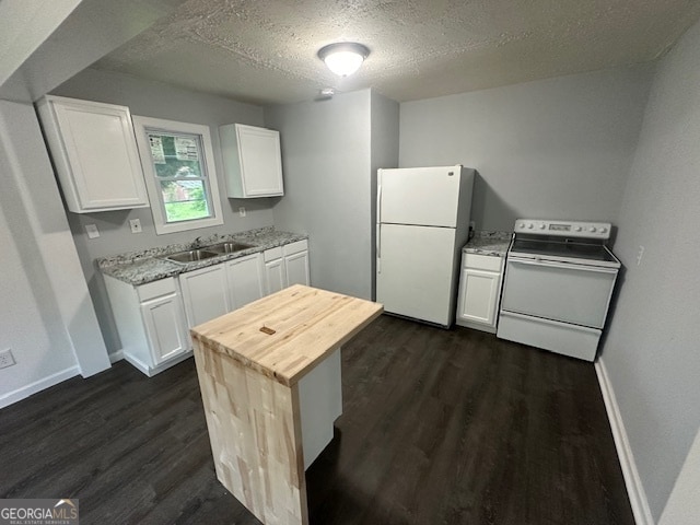 kitchen with white appliances, white cabinets, dark wood-type flooring, and a textured ceiling