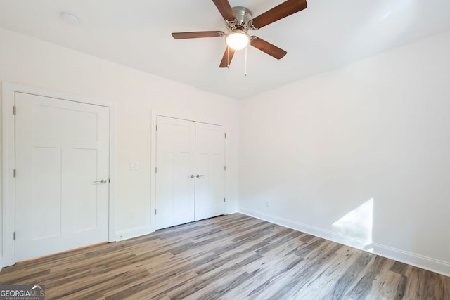 unfurnished bedroom featuring ceiling fan and light hardwood / wood-style floors