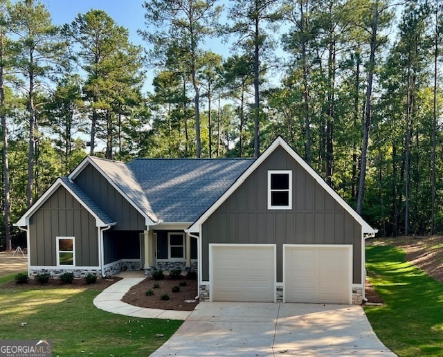 view of front of property featuring a garage and a front lawn