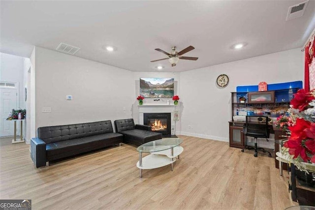 living room featuring ceiling fan and light wood-type flooring