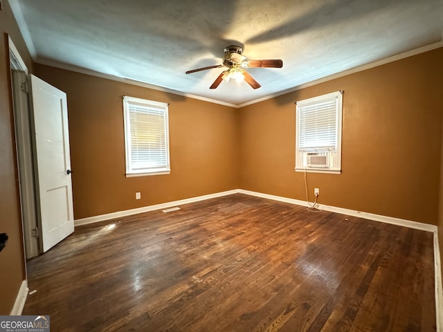 empty room featuring ceiling fan, wood-type flooring, ornamental molding, and a healthy amount of sunlight