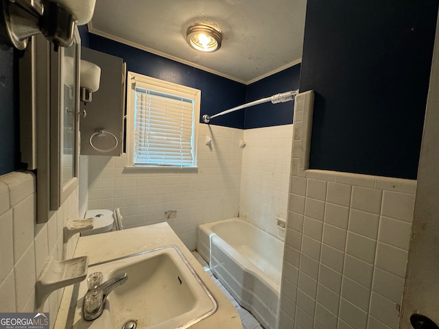 bathroom with tiled shower / bath, tile walls, and sink